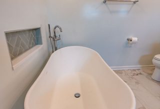 Free-standing bathtub in contemporary bathroom remodeling in Champaign Urbana
