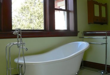 Claw foot tub under beautiful window in historic home bathroom remodel in Sidney IL