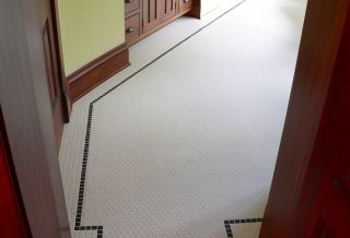 Hexagonal tile with square tile border in historic home bathroom remodel in Sidney IL