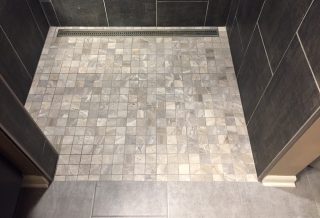 Square mosaic ceramic shower floor tiles in bathroom shower remodel