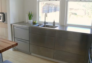 Stainless steel cabinets and counters in kitchen remodel in historic Champaign