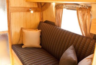 Couch converts to bed in Vintage Airstream remodel