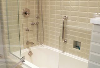 Brushed nickel shower fixtures and tiled tube surround in historic restored Victorian farmhouse in East Central IL