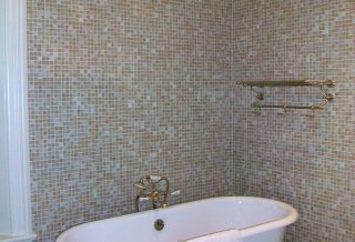 Clawfoot tub and tiled walls in historic restored Victorian farmhouse in East Central IL