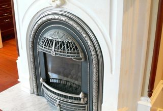 Fireplace surround with fancy grillwork in historic restoration of Victorian Italinate Homestead in East Central IL