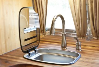 Lift-up top on kitchen sink in Vintage Airstream remodel