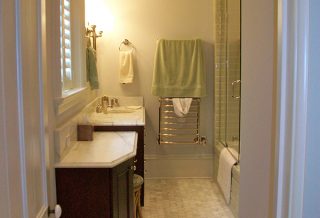Marble topped vanity and brushed nickel towel warmer in historic restored Victorian farmhouse in East Central IL