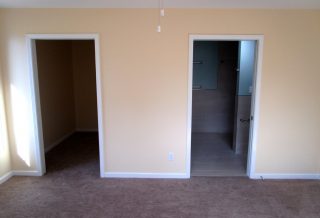 Open sliding closet and bathroom doors in bedroom addition