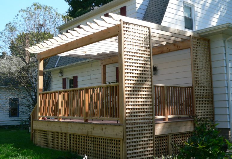 New cedar deck construction with lattice, pergola, stairs, and rails.