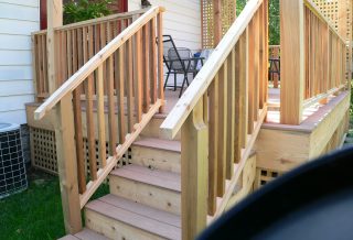 New cedar deck construction with lattice, stairs, and rails.