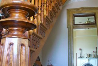 Restored newel post and banister in historic restoration of Victorian farmhouse in East Central IL