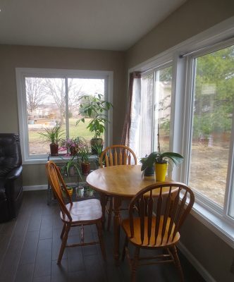 Table and chairs near picture windows in home addition project in Urbana IL