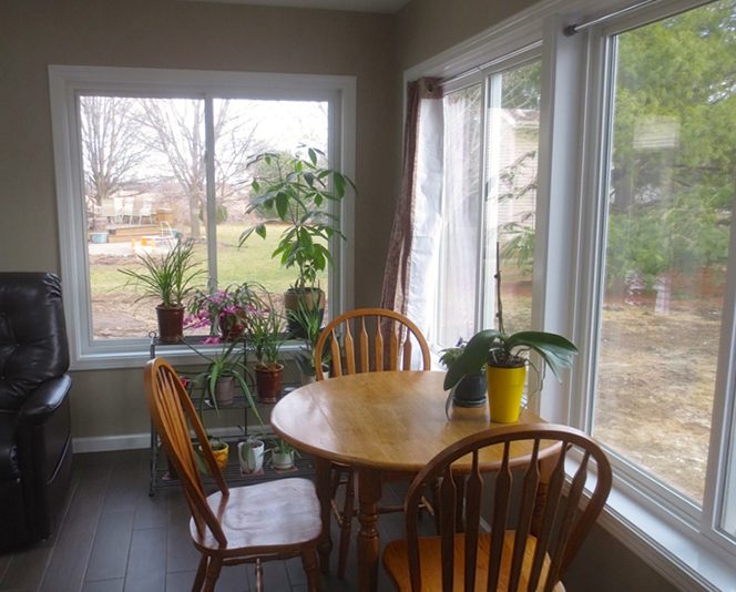 Table and chairs near picture windows in home addition project in Urbana IL
