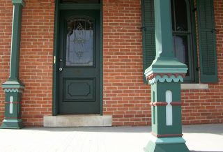 Front door and post of historic restored Victorian farmhouse in East Central IL