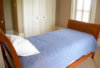 Sleight bed in remodeled bedroom of historic restored Victorian farmhouse in East Central IL