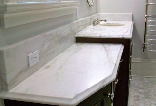 White marble vanity top in farmhouse bathroom remodel