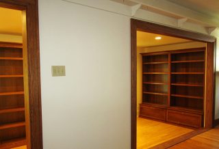 Home library addition features sustainable bamboo flooring, custom trim milled to match the original, Amish-made oak bookcases, and double-glazed, insulated, casement windows.