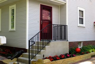 New steps, door, custom made wrought iron handrail in home library addition.