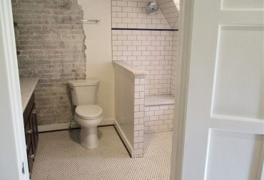 Exposed brick with organic edges in master bathroom remodel.