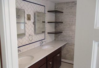 Floating shelves, cantilevered countertops, exposed brick with organic edges in master bathroom remodel.