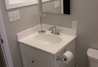 Glass shelving and vanity in bathroom remodel in Champaign, IL.