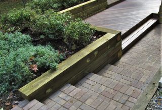 A deck rebuild using ground-contact rated, treated lumber and premium grade, composite decking with hidden fasteners.