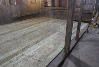 Timbers, gable vents, floor boards, and siding were replaced, and a new stairwell and guard rails were constructed in this unique barn restoration.