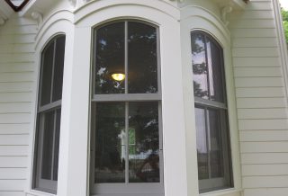 Restored windows, part of energy efficient exterior siding and trim restoration of an historic farmstead in Mahomet, IL.