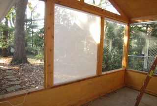 Roomy gable roof screened-in porch remodel with cedar trim and cathedral ceiling.