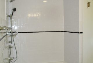 1920s bathroom remodel includes new period fixtures and new wall tile.