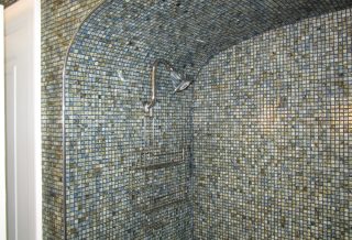 Mosaic tiled tub area in bathroom remodel project in West Urbana, IL.