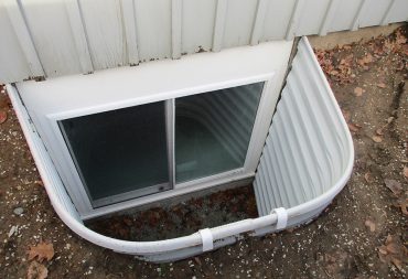 Home improvement construction project to install a basement egress window with escape well.