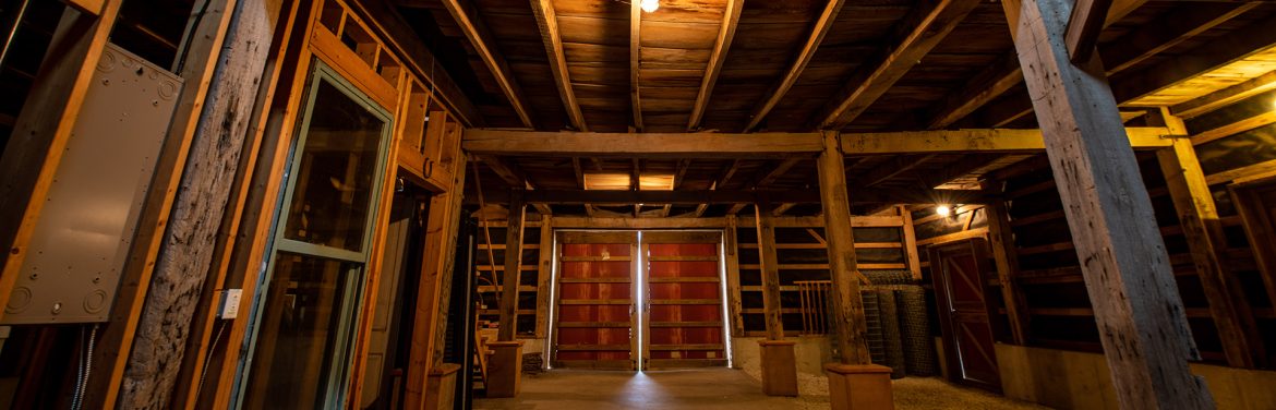 Timber frame barn restoration project by New Prairie Construction