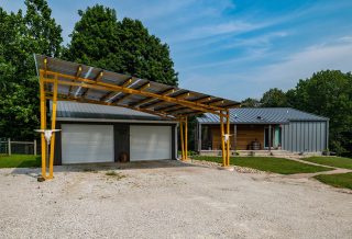 Net zero home construction in Fairmont, IL, with solar carport pergola.
