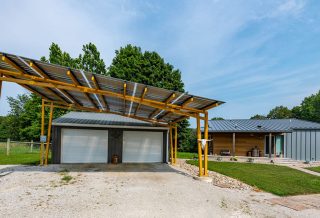 Net zero home construction in Fairmont, IL, with solar carport pergola.